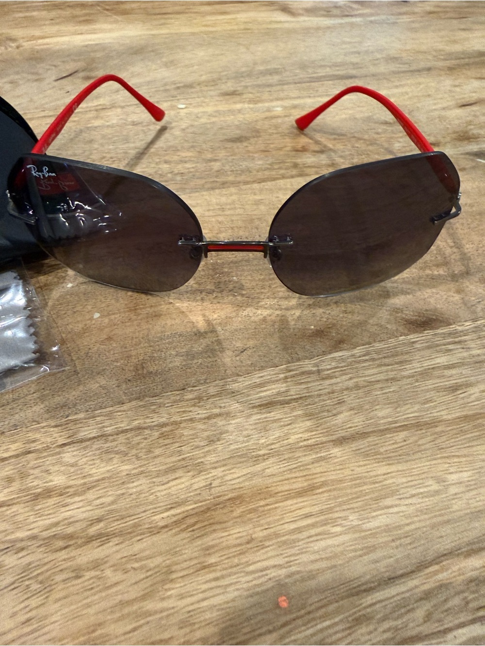 Ray-Ban Women’s Rimless Sunglasses with Black Lenses and Red Temples